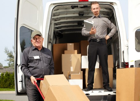 Man with van loading furniture in Plumstead street